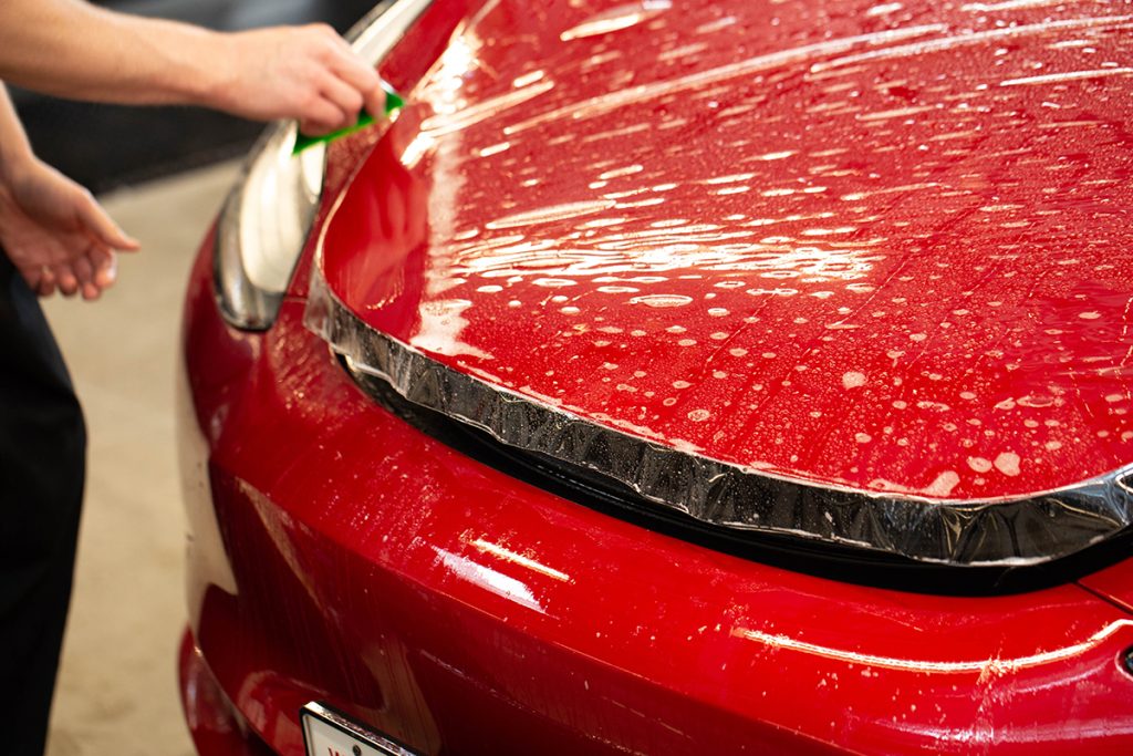 STEK Paint Production Film on bright red car